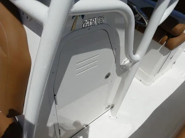 Slide: The Image of 2025 Key West 239 FS boat interior with white console and brown seating. - 19