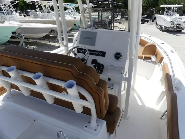 Slide: The Image of 2025 Key West 239 FS boat interior with helm, seating, and rod holders. - 8