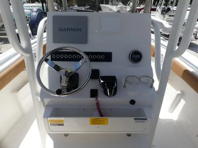 Slide: The Image of 2025 Key West 239 FS boat console with Garmin navigation, steering wheel, and controls. - 9