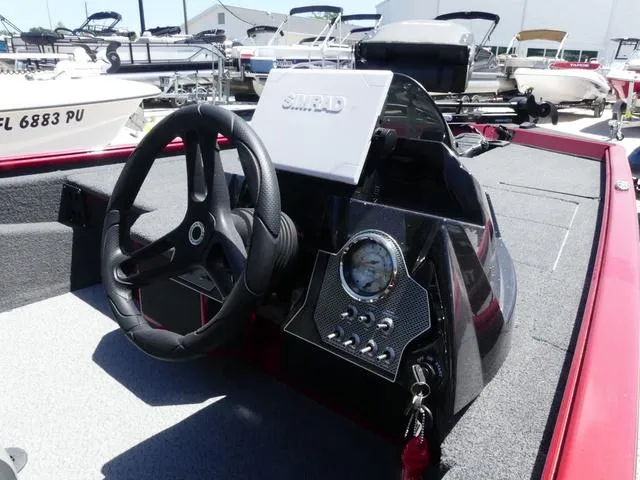 Slide: The Image of 2022 Lund 2175 Pro V boat dashboard with steering wheel and control panel. - 13