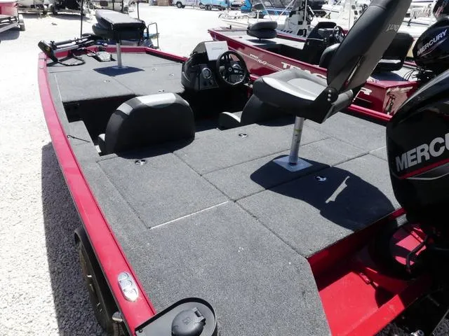 Slide: The Image of 2022 Lund 2175 Pro V fishing boat with red exterior and spacious deck. - 6