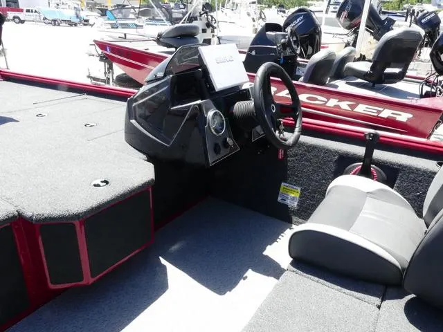 Slide: The Image of 2022 Lund 2175 Pro V boat interior with steering console and seating. - 8