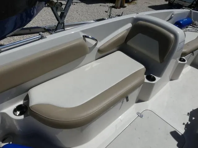 Slide: The Image of 2017 Stingray 182SC O/B boat interior with beige seating and cup holders. - 10