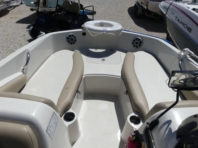 Slide: The Image of 2017 Stingray 182SC O/B boat interior with beige seating and cup holders. - 11