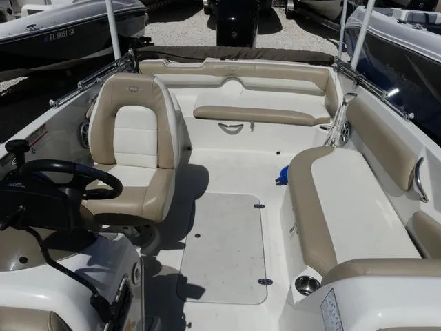 Slide: The Image of 2017 Stingray 182SC O/B boat interior with beige seating and steering console. - 12