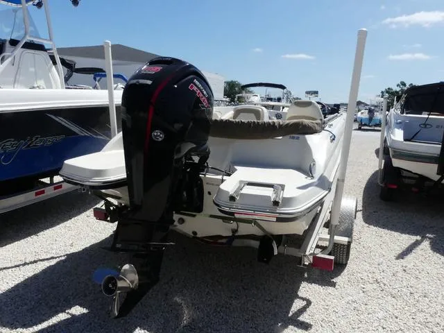 Slide: The Image of 2017 Stingray 182SC O/B boat with outboard motor, displayed in a sunny marina. - 3