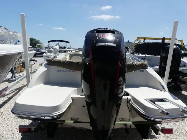 Slide: The Image of 2017 Stingray 182SC O/B boat with Mercury outboard engine, parked on gravel lot. - 4