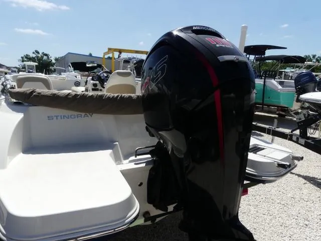 Slide: The Image of 2017 Stingray 182SC O/B boat with Mercury outboard motor, parked on gravel. - 5