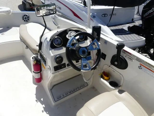 Slide: The Image of 2017 Stingray 182SC O/B boat cockpit with steering wheel and controls. - 6