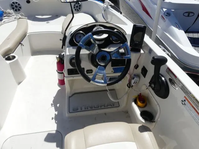 Slide: The Image of 2017 Stingray 182SC O/B boat cockpit with steering wheel and controls. - 7