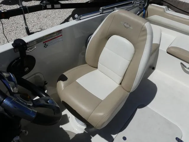 Slide: The Image of 2017 Stingray 182SC O/B boat interior with beige and white captain's seat. - 8