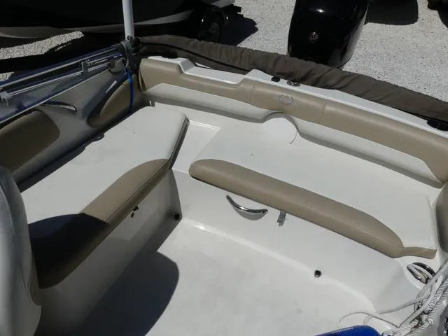 Slide: The Image of 2017 Stingray 182SC O/B boat interior with beige seating and white deck. - 9