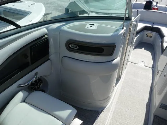 Slide: The Image of 2023 Crownline 290 XSS boat interior with sleek seating and modern dashboard design. - 12