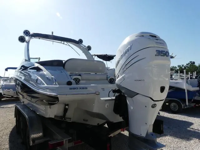 Slide: The Image of 2023 Crownline 290 XSS boat with Mercury 350 engine on trailer, sunny day. - 4