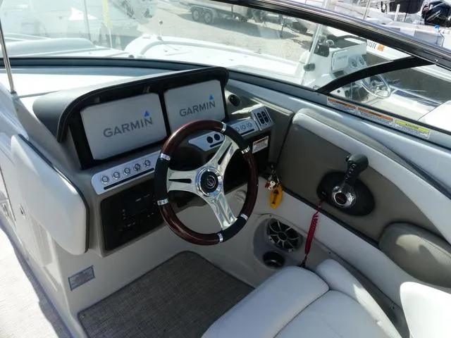 Slide: The Image of 2023 Crownline 290 XSS boat cockpit with Garmin displays and modern steering wheel. - 8