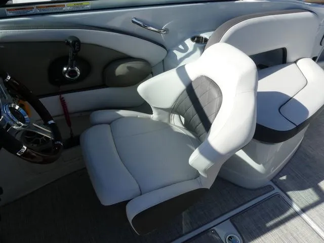 Slide: The Image of 2023 Crownline 290 XSS boat interior with modern white and gray seating. - 9