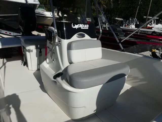 Slide: The Image of 2024 Mako Pro Skiff 15 CC boat interior with cushioned seating and console. - 12