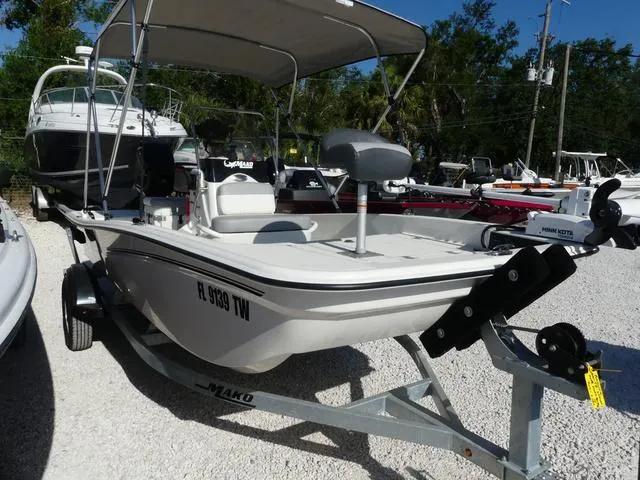 Slide: The Image of 2024 Mako Pro Skiff 15 CC boat on trailer, parked outdoors. - 3