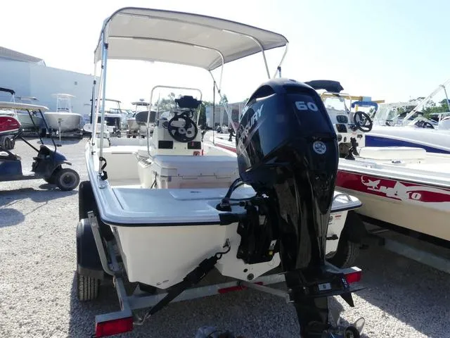 Slide: The Image of 2024 Mako Pro Skiff 15 CC with Mercury 60 engine, parked on gravel. - 4