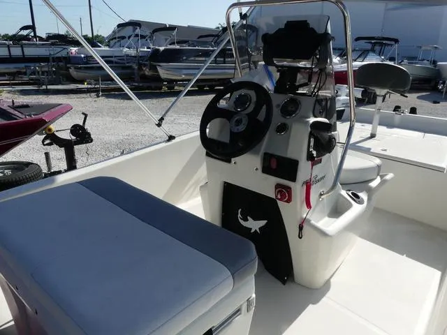 Slide: The Image of 2024 Mako Pro Skiff 15 CC boat interior with steering console and seating. - 7