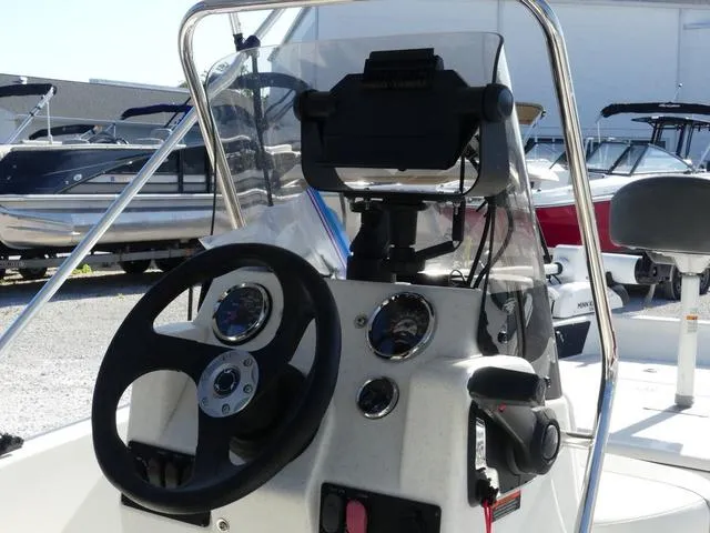 Slide: The Image of 2024 Mako Pro Skiff 15 CC boat console with steering wheel and controls. - 8