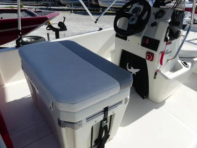 Slide: The Image of 2024 Mako Pro Skiff 15 CC interior with console and cushioned seat. - 9