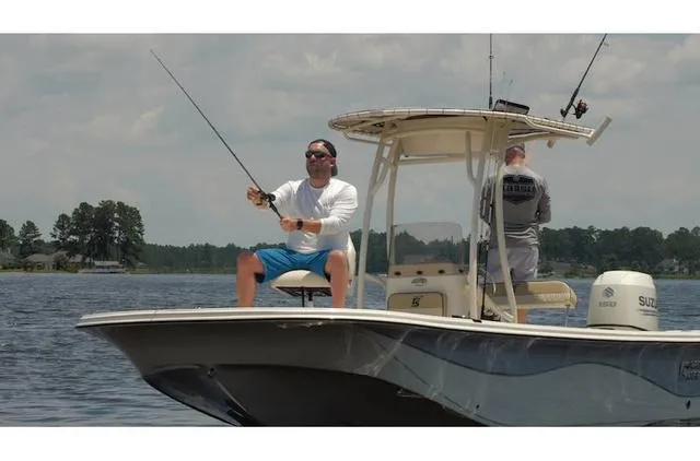 Slide: The Image of Two people fishing on a 2021 Carolina Skiff 21LS boat in a lake. - 10
