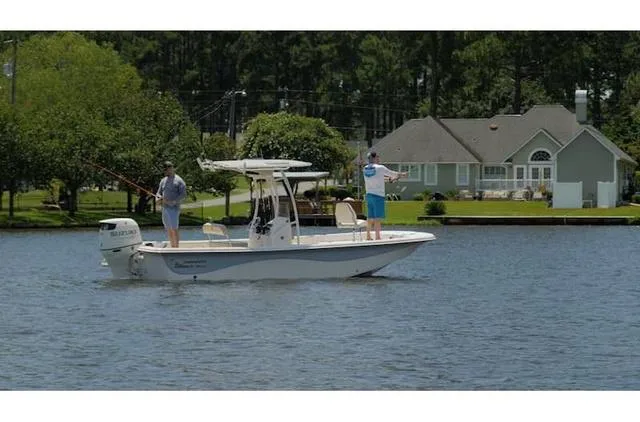 Slide: The Image of 2021 Carolina Skiff 21LS boat with two people fishing on a calm lake. - 6