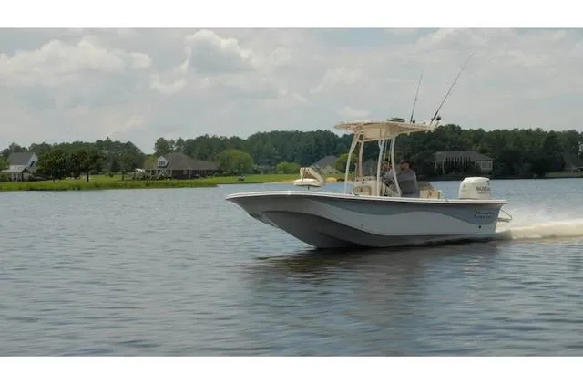 Slide: The Image of 2021 Carolina Skiff 21LS boat cruising on a calm lake with scenic background. - 8