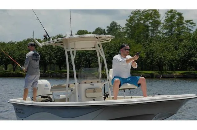Slide: The Image of Two men fishing on a 2021 Carolina Skiff 21LS boat in a scenic waterway. - 9
