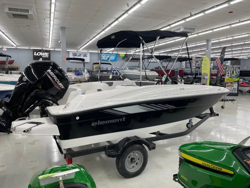 Slide: The Image of 2025 Bayliner Element E16 boat displayed indoors with a Mercury engine. - 4
