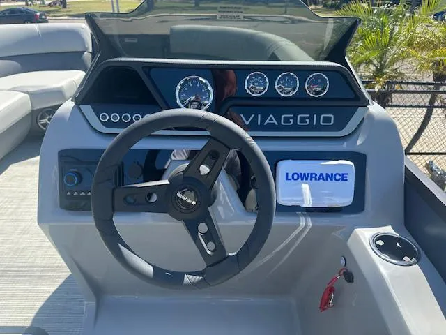 Slide: The Image of 2024 Viaggio V 20 U boat dashboard with steering wheel and Lowrance navigation system. - 6