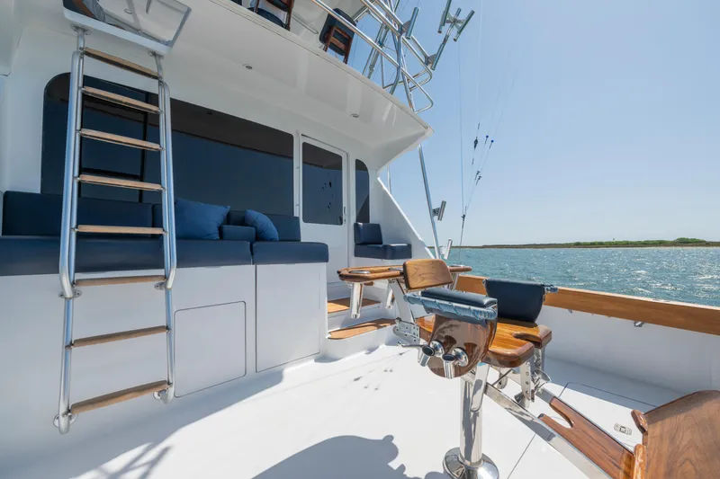 Slide: The Image of 2001 Viking Convertible yacht deck with seating, ladder, and ocean view. - 14