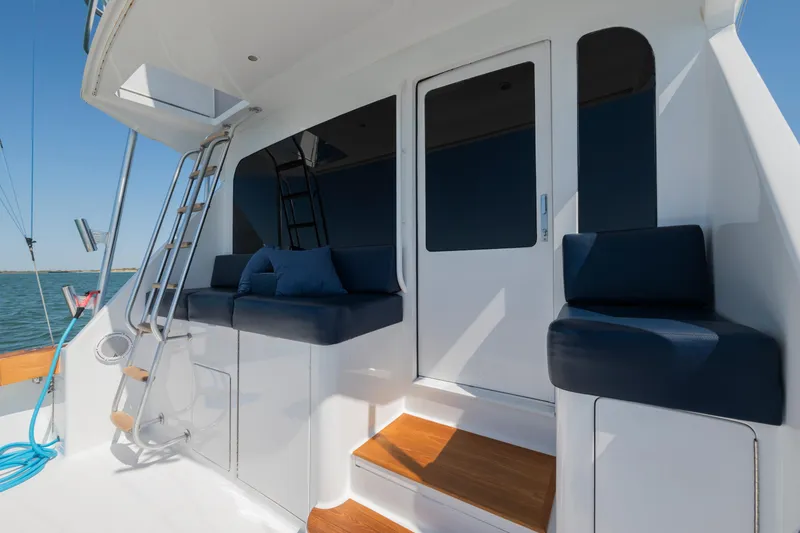 Slide: The Image of 2001 Viking Convertible yacht deck with cushioned seating and ocean view. - 16