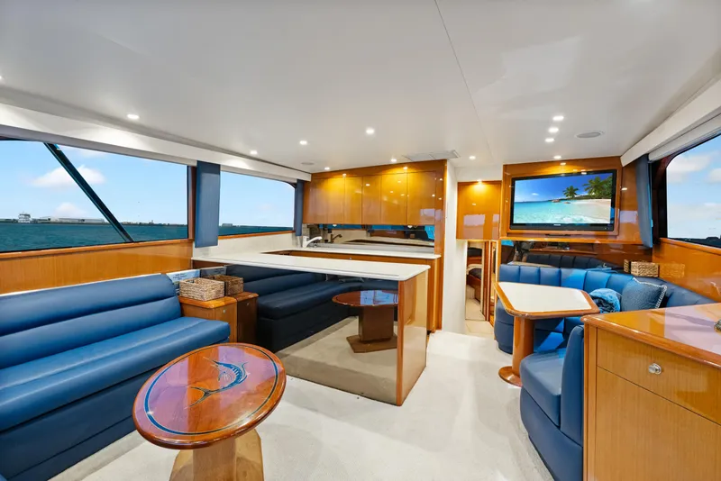 Slide: The Image of Luxurious interior of a 2001 Viking Convertible yacht with elegant wood finishes and blue seating. - 17