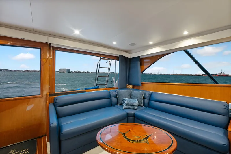 Slide: The Image of Luxurious interior of a 2001 Viking Convertible yacht with blue seating and ocean view. - 21