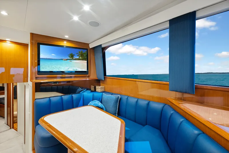 Slide: The Image of Luxurious interior of a 2001 Viking Convertible yacht with ocean view and blue seating. - 22