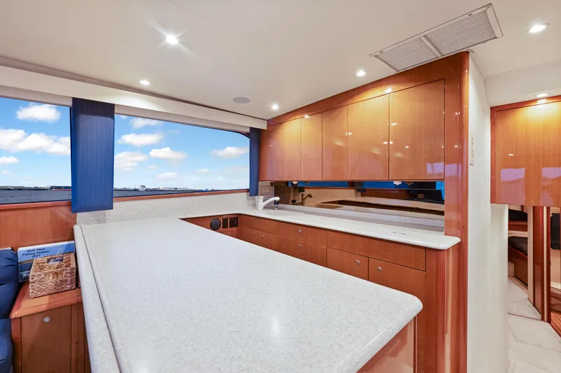 Slide: The Image of Luxurious interior of a 2001 Viking Convertible yacht with modern kitchen and ocean view. - 23