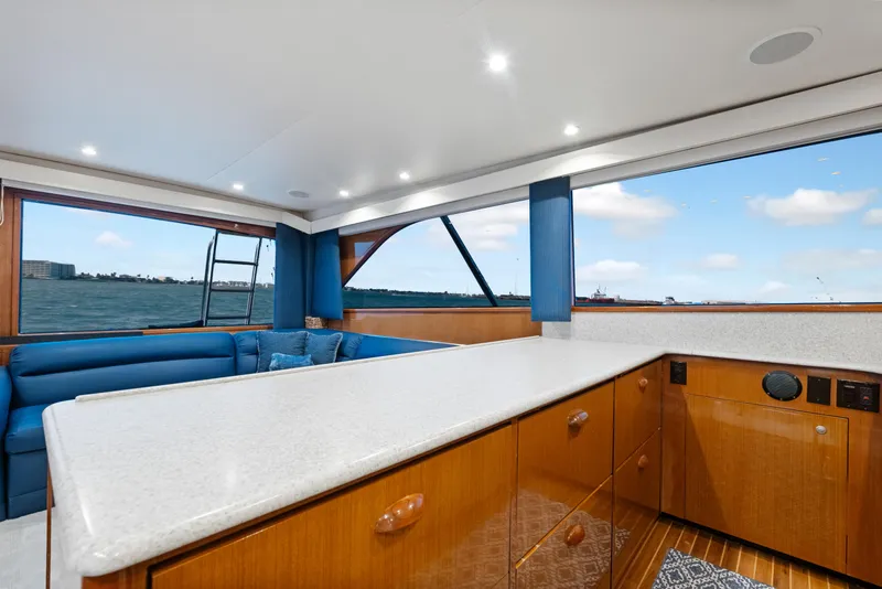 Slide: The Image of Luxurious interior of a 2001 Viking Convertible yacht with ocean view and elegant wood finishes. - 25
