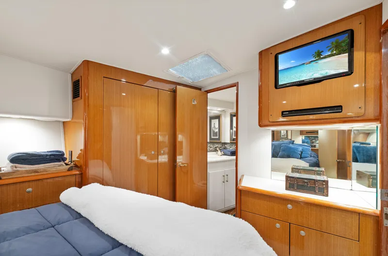 Slide: The Image of Luxurious 2001 Viking Convertible yacht bedroom with wood cabinetry and mounted TV. - 27