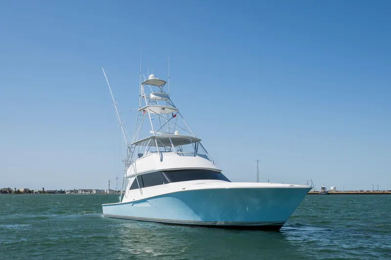 Slide: The Image of 2001 Viking Convertible yacht on open water under clear blue sky. - 3
