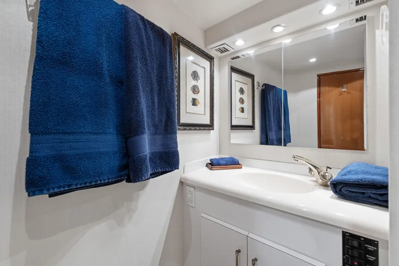 Slide: The Image of Bathroom in 2001 Viking Convertible yacht with blue towels and modern fixtures. - 30