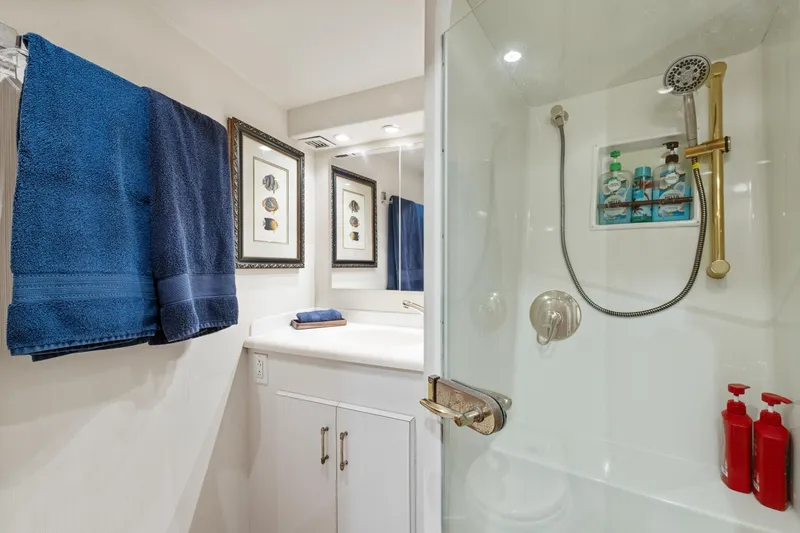 Slide: The Image of Bathroom interior of 2001 Viking Convertible yacht with shower and blue towels. - 31