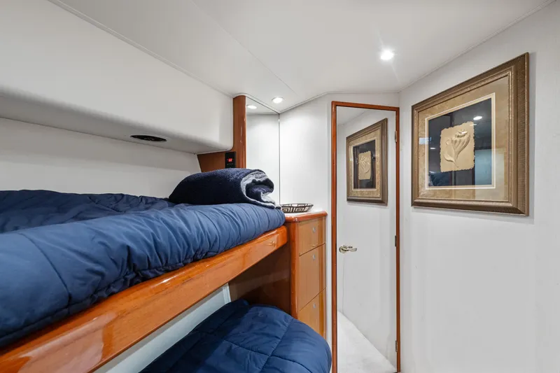 Slide: The Image of 2001 Viking Convertible yacht cabin with bunk beds and framed artwork. - 33
