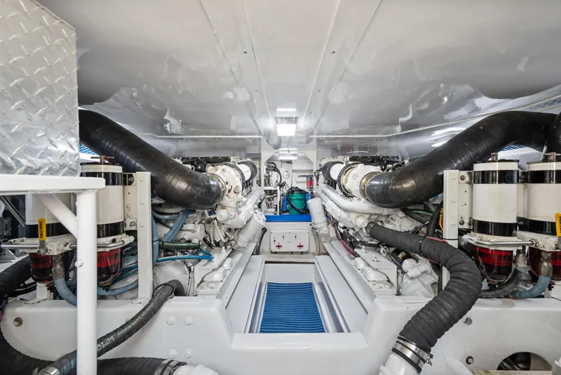 Slide: The Image of Engine room of a 2001 Viking Convertible yacht, showcasing dual engines and piping. - 35
