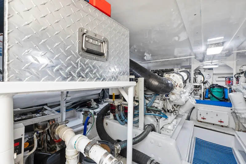 Slide: The Image of Engine room of a 2001 Viking Convertible yacht, featuring machinery and storage compartments. - 37
