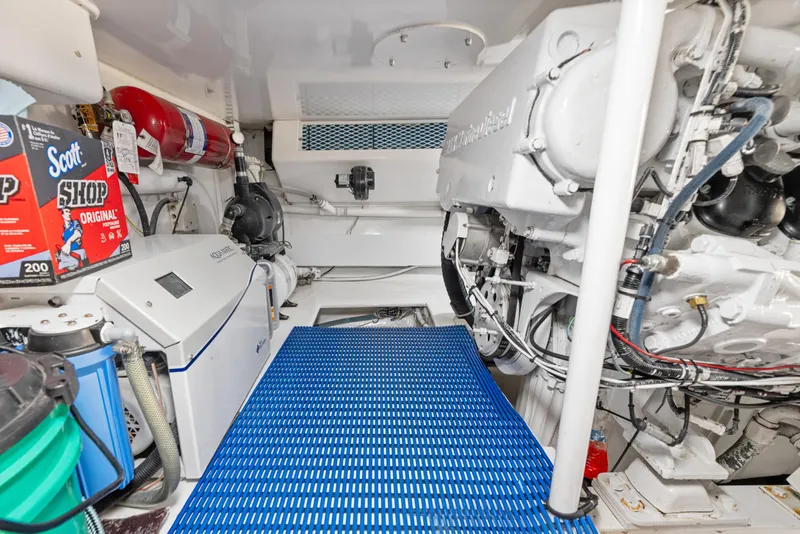 Slide: The Image of Engine room of a 2001 Viking Convertible boat with equipment and storage items. - 39