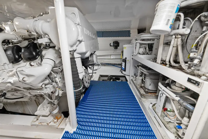 Slide: The Image of Engine room of a 2001 Viking Convertible boat with visible machinery and blue flooring. - 40