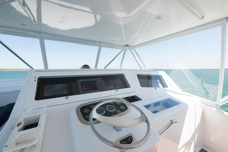 Slide: The Image of 2001 Viking Convertible yacht helm with ocean view, featuring modern navigation equipment. - 5