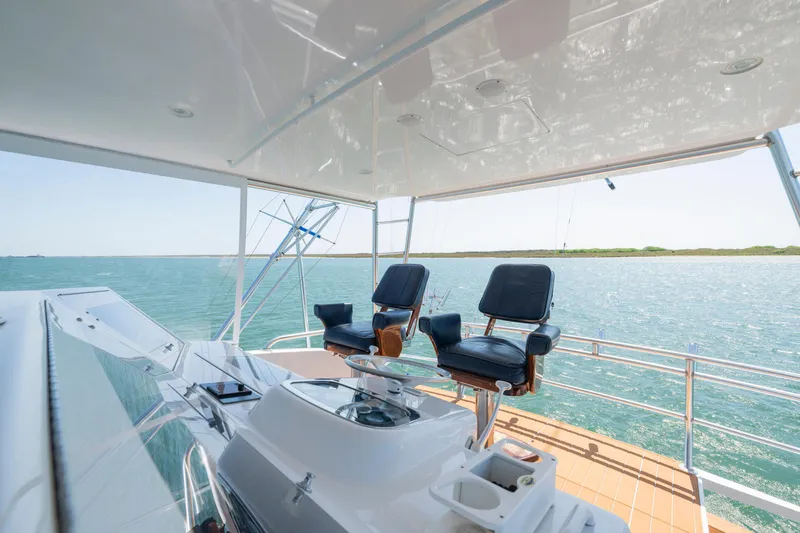 Slide: The Image of 2001 Viking Convertible yacht helm with ocean view and comfortable seating. - 7